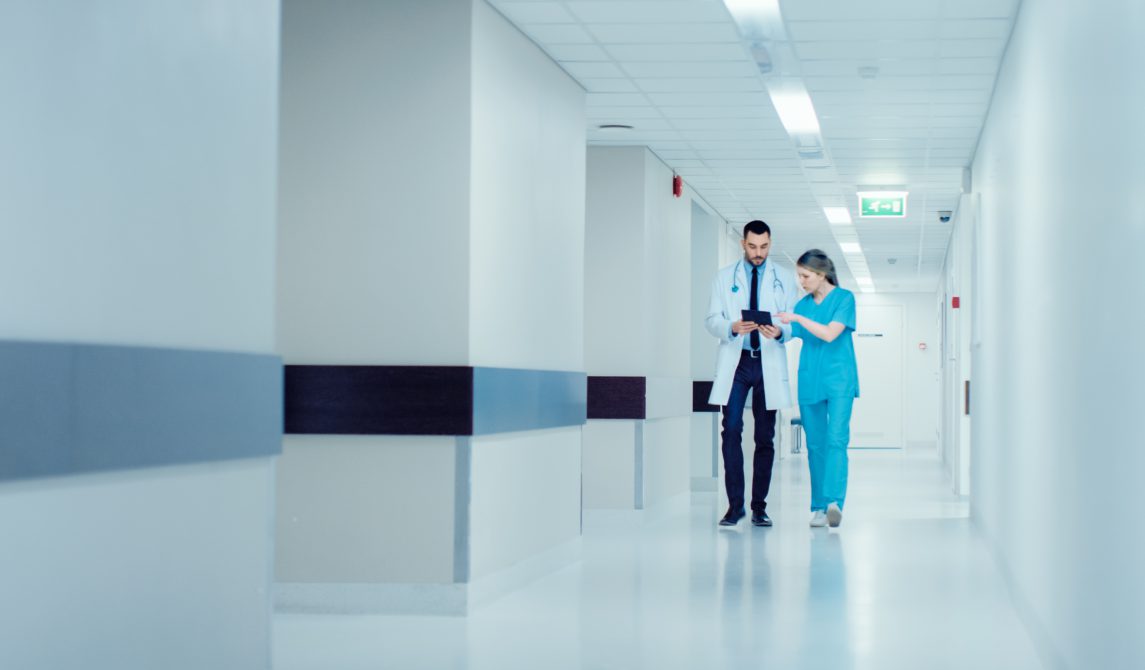 Physician and surgeon discussing patient vitals