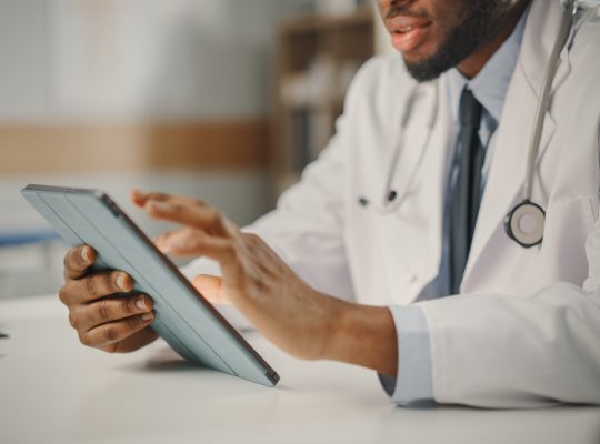 Physician checking patient's vitals on a tablet